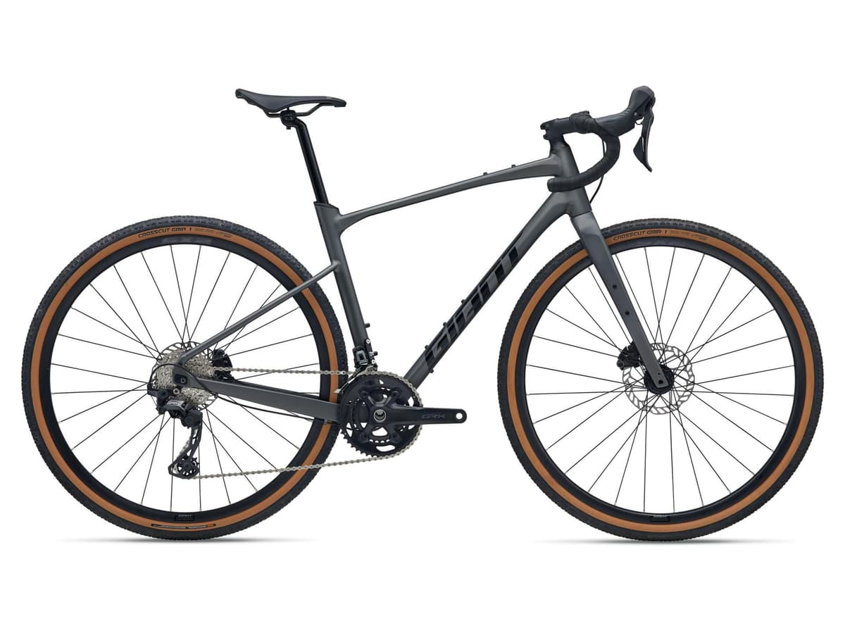 Giant Revolt 2 gravel bike in dark grey with tan-wall tires on a white background.
